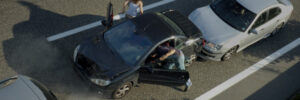 Image of car accident on highway. People getting out of car.